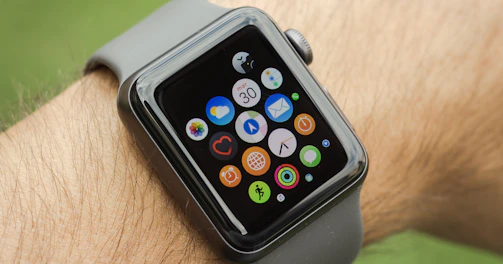 A smartwatch on a wrist displaying notifications against a blurred city background.