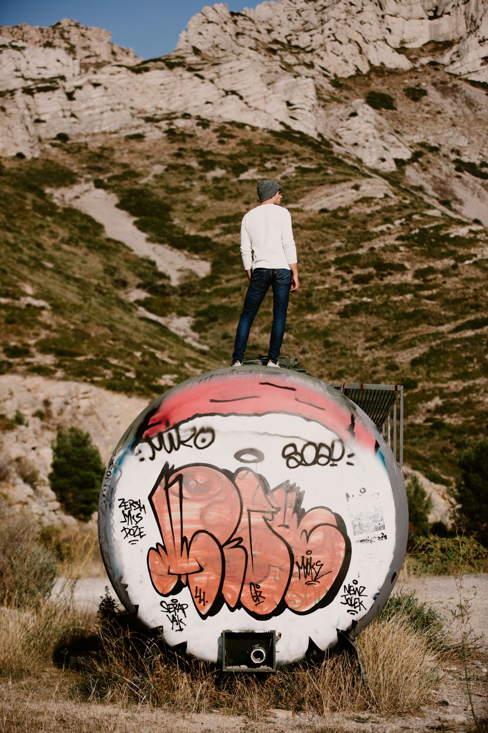 man standing near rocky mountain during daytime