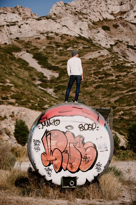 man standing near rocky mountain during daytime in Marseille France