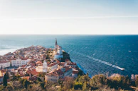 brown roof buildings near sea ocean taken at daytime