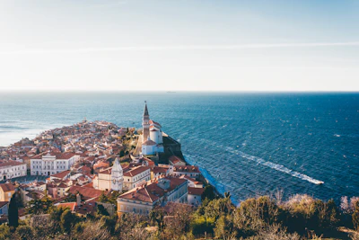 Piran from above: terracotta roofs on the point, the bell tower and the open Adriatic