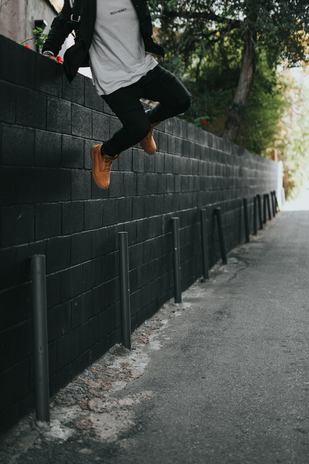 man jumping over fence