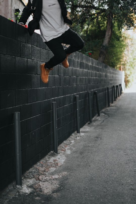 man jumping over fence in West Hollywood United States