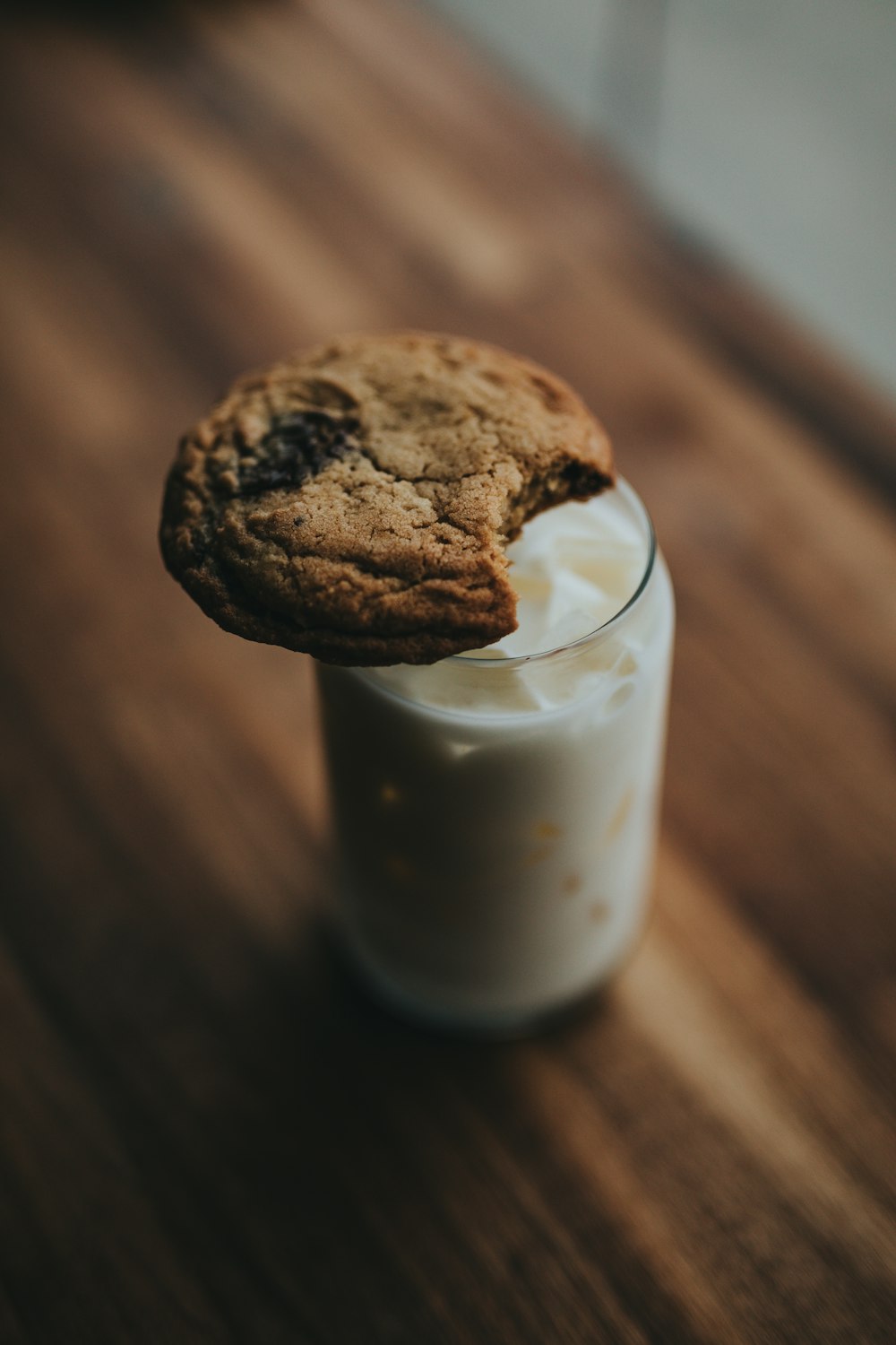 round cookie on clear glass jar with white sauce