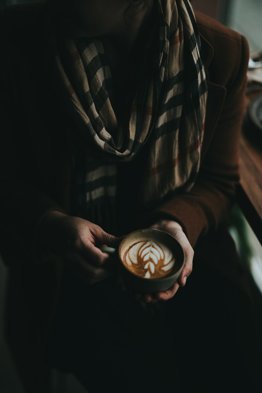 person holding latte art
