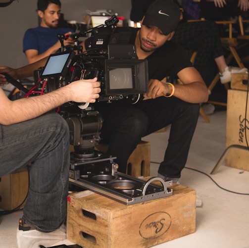 two men setting up camera inside room