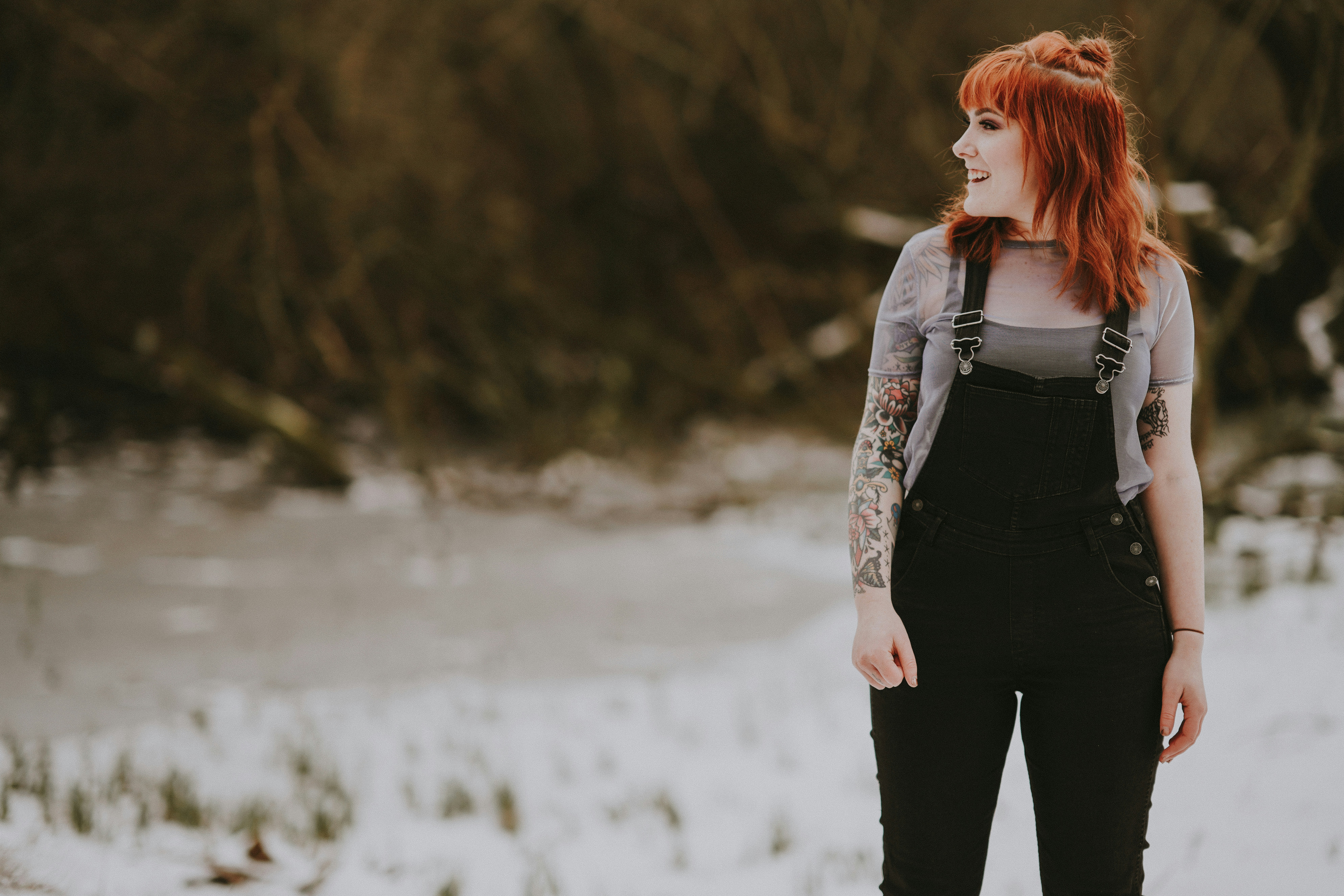 Tattooed woman wearing dungarees