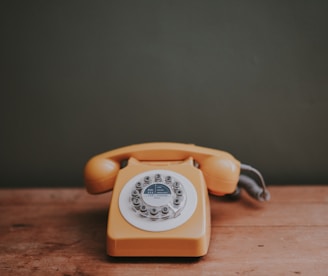 brown rotary dial telephone in gray painted room