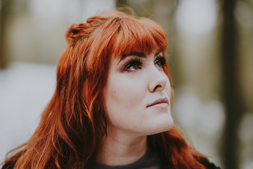 woman looking up wearing black top