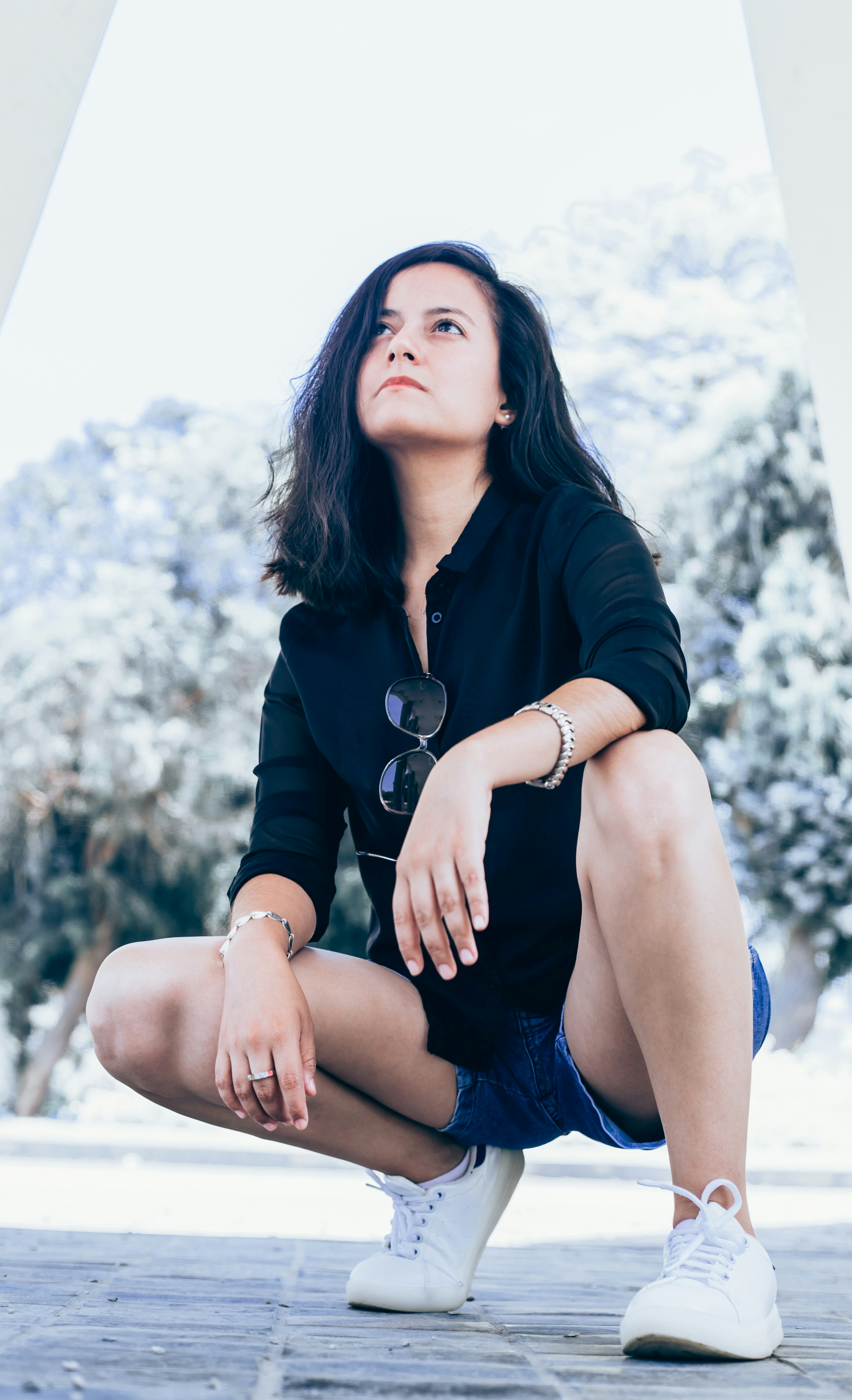 woman wearing black dress shirt on gray concrete pavement during daytime