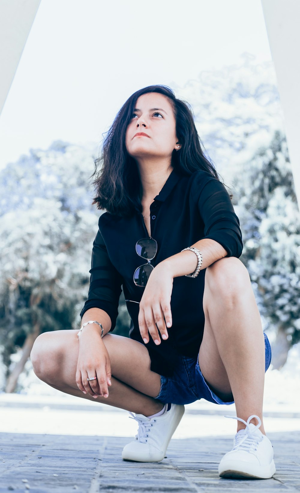 woman wearing black dress shirt on gray concrete pavement during daytime