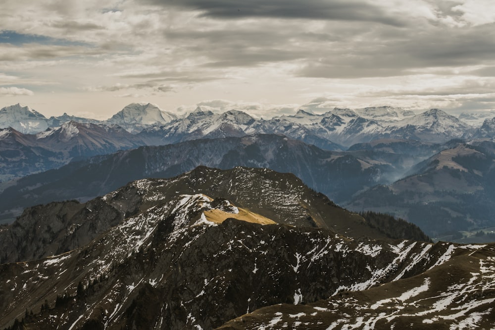 aerial photography of mountains under cloudy sky