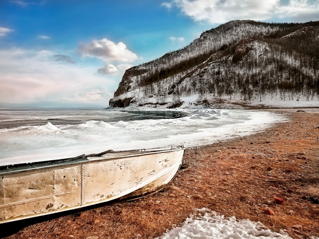 beige boat on shore, Went to the beach<p></figure>Frozen water —</p><p>Couldn´t swim!
