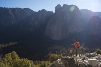 man standing on top of mountain