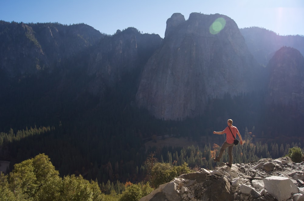 man standing on top of mountain