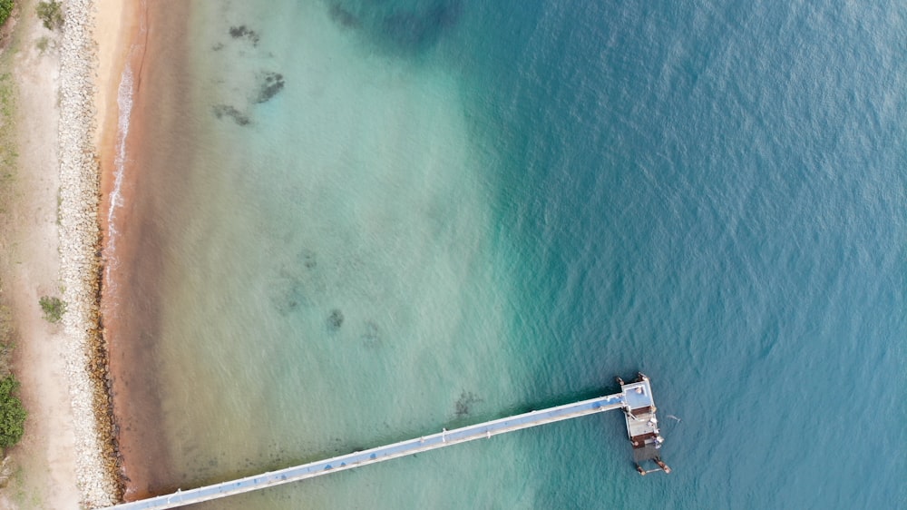 aerial photography of wooden dock on the ocean