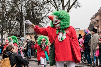 Crowd enjoying a vibrant carnival street party with colorful costumes and confetti