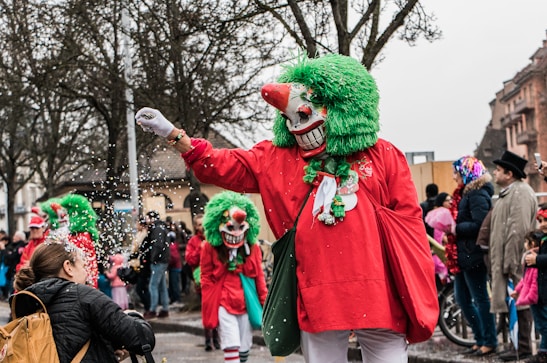 Crowd enjoying a vibrant carnival street party with colorful costumes and confetti