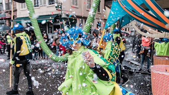 Vibrant carnival crowd enjoying a lively street parade with colorful costumes and confetti.