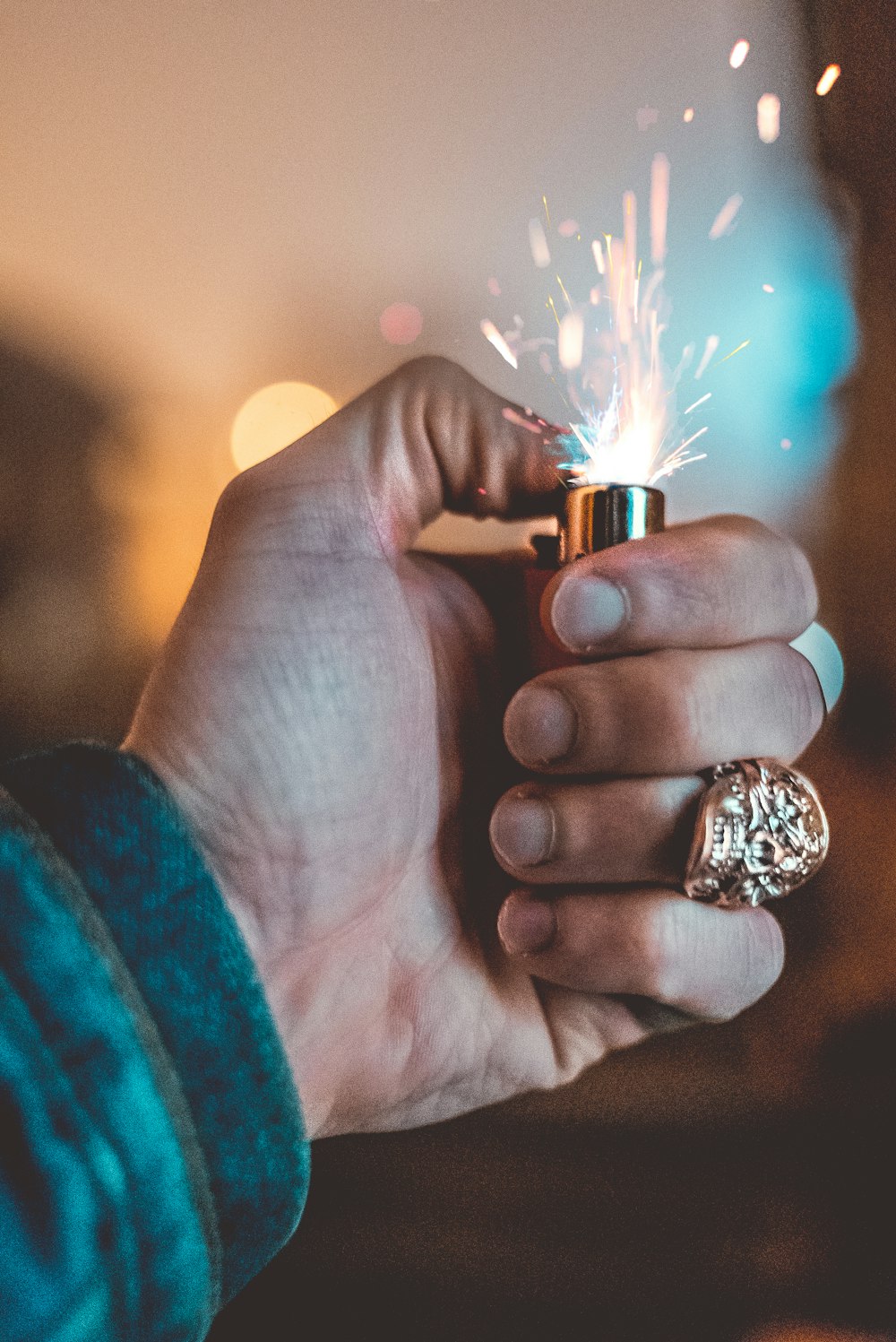 person holding lighted lighter