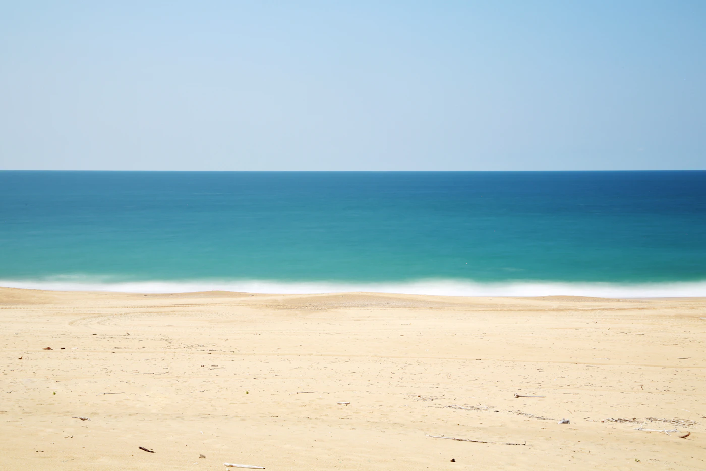Wooden pier extending above a sandy Atlantic beach