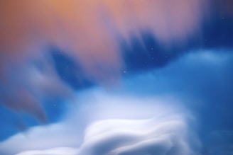 A dreamy landscape with swirling clouds and stars, evoking imagination and inspiration.