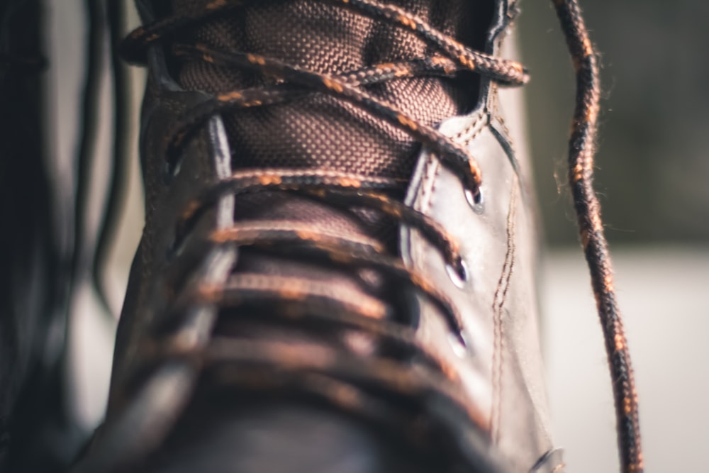 person wearing brown and black hiking shoe