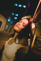 women wearing white cold-shoulder shirt during night time