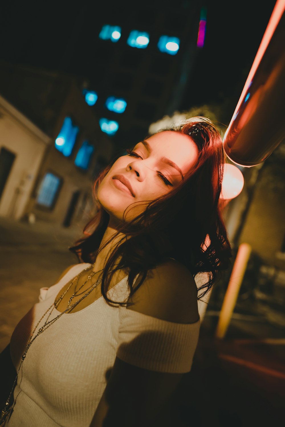 women wearing white cold-shoulder shirt during night time