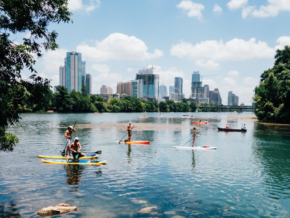 people riding paddle boards on the lake