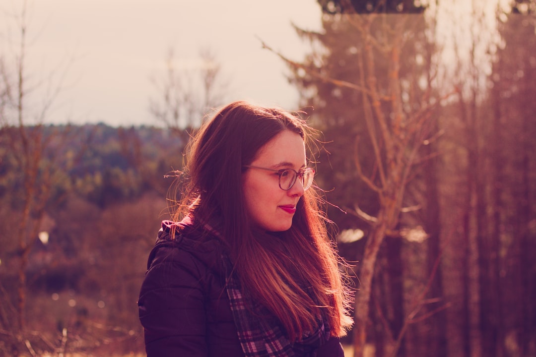 woman wearing black jacket and eyeglasses