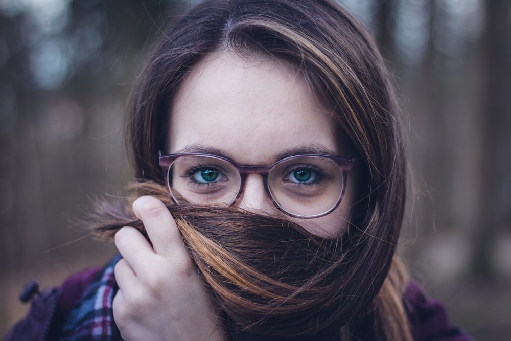 woman holding her hair during daytime