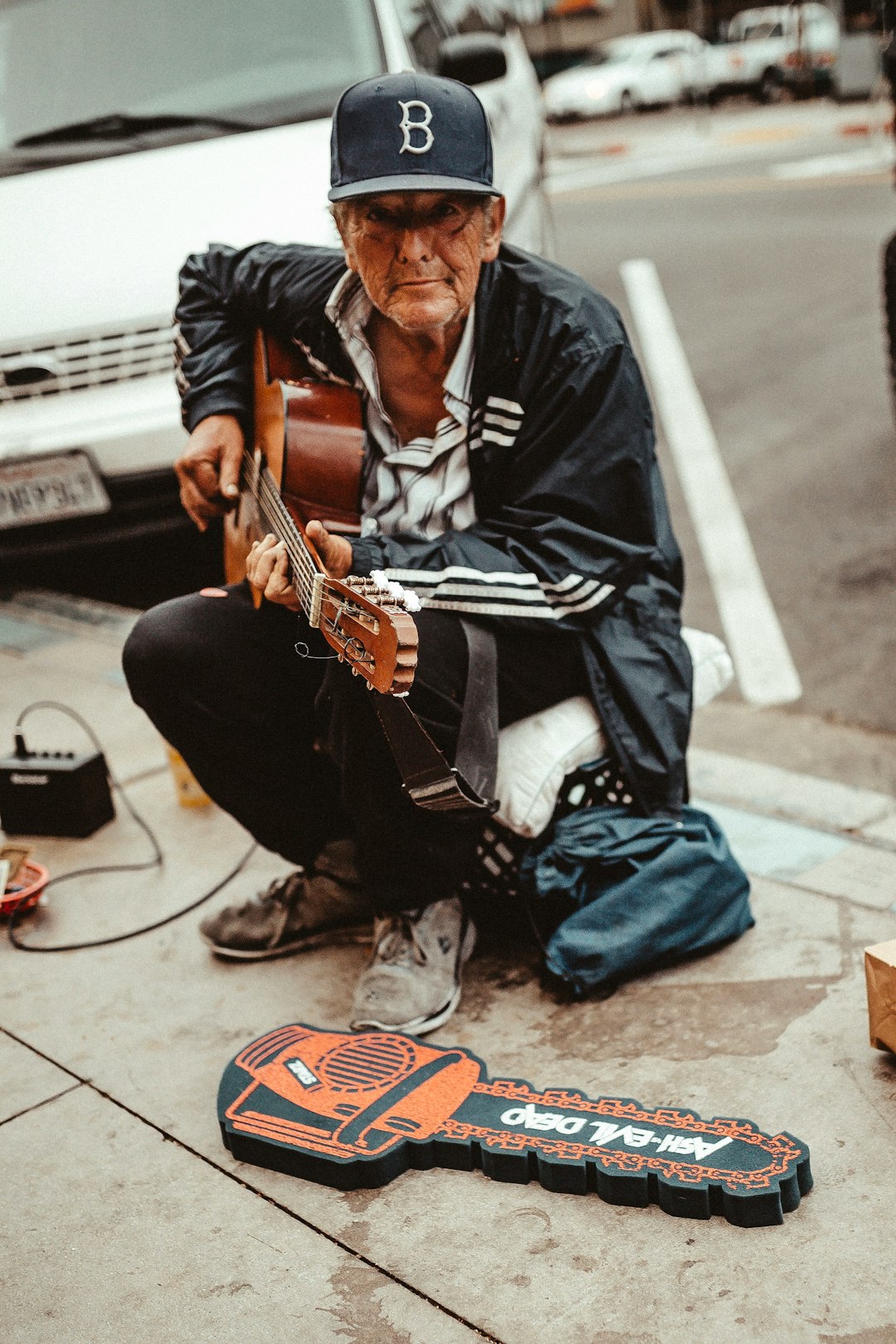 man playing guitar while sitting