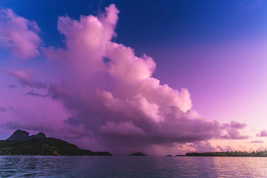 landscape photography of mountain surrounded by body of water during daytime