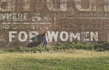 girl standing near brown building during daytime