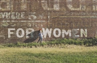 girl standing near brown building during daytime