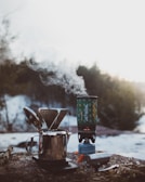 Compact camping stove glowing warmly on a forest floor