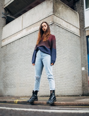 woman standing on sidewalk during daytime