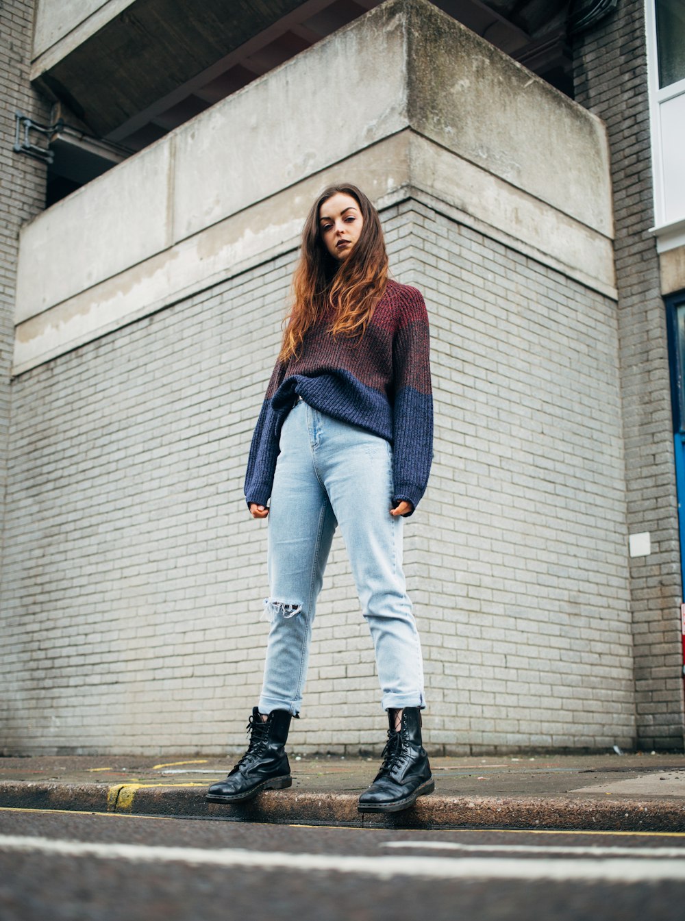 woman standing on sidewalk during daytime