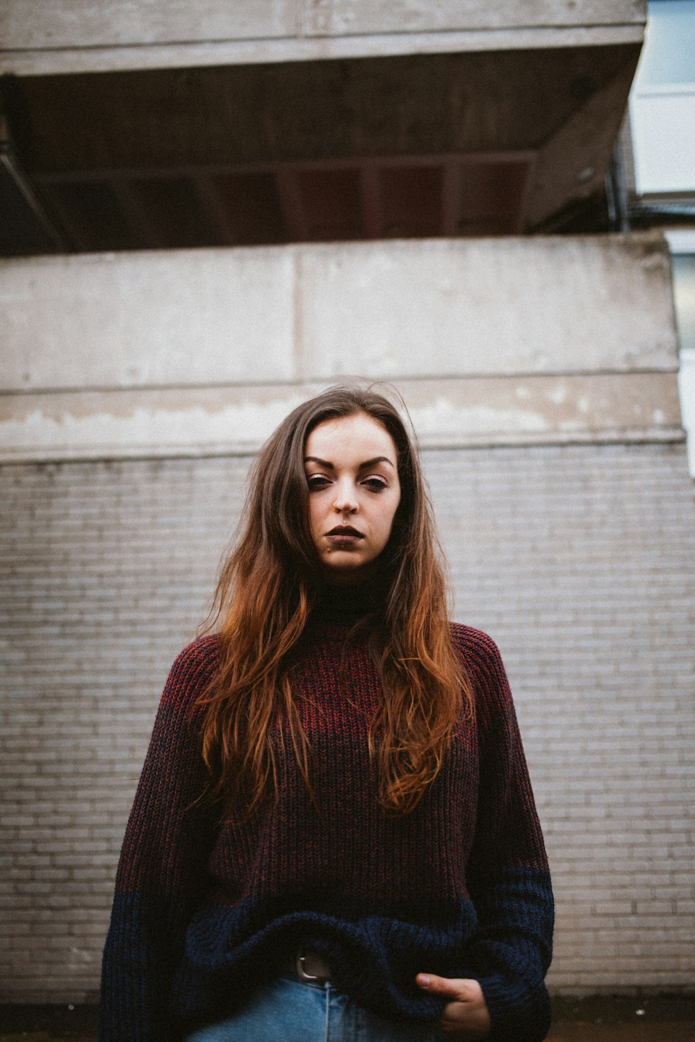 woman standing near brown building