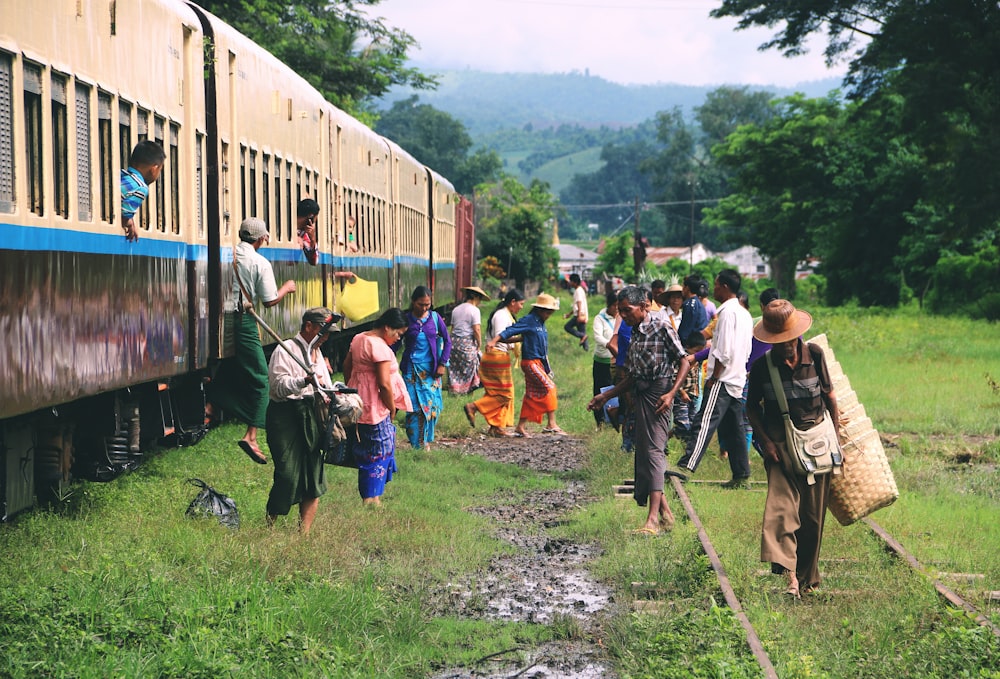 group of people standing outside train