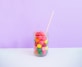clear beverage jar wit straw on table