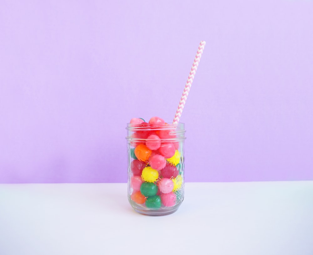 clear beverage jar wit straw on table