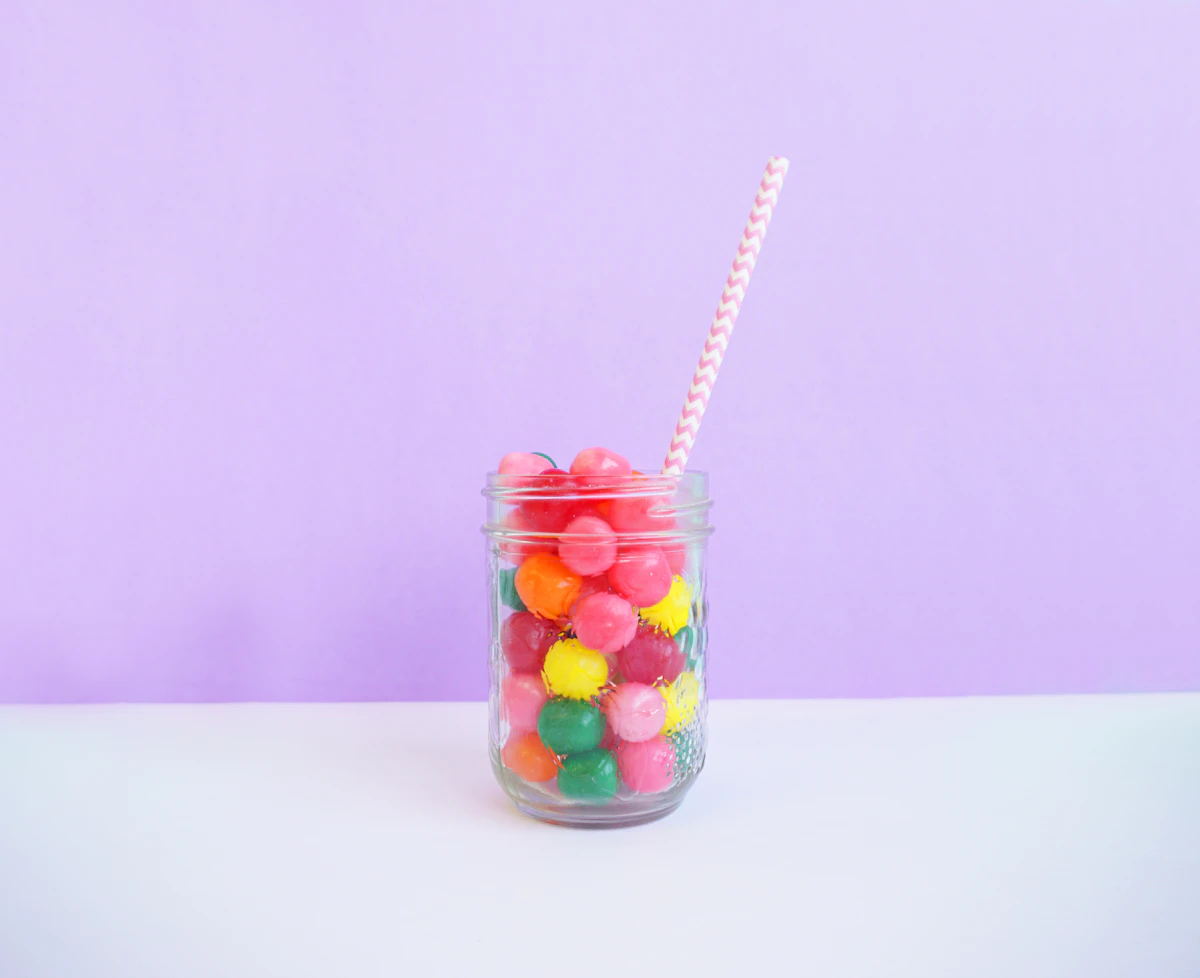 clear beverage jar wit straw on table