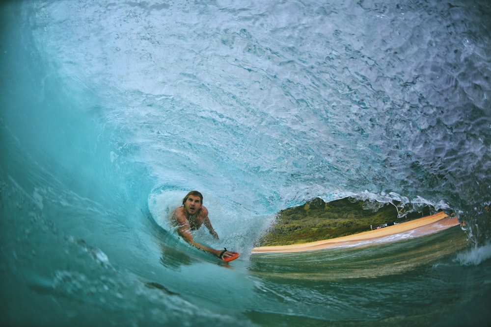 man surfing in wave on water