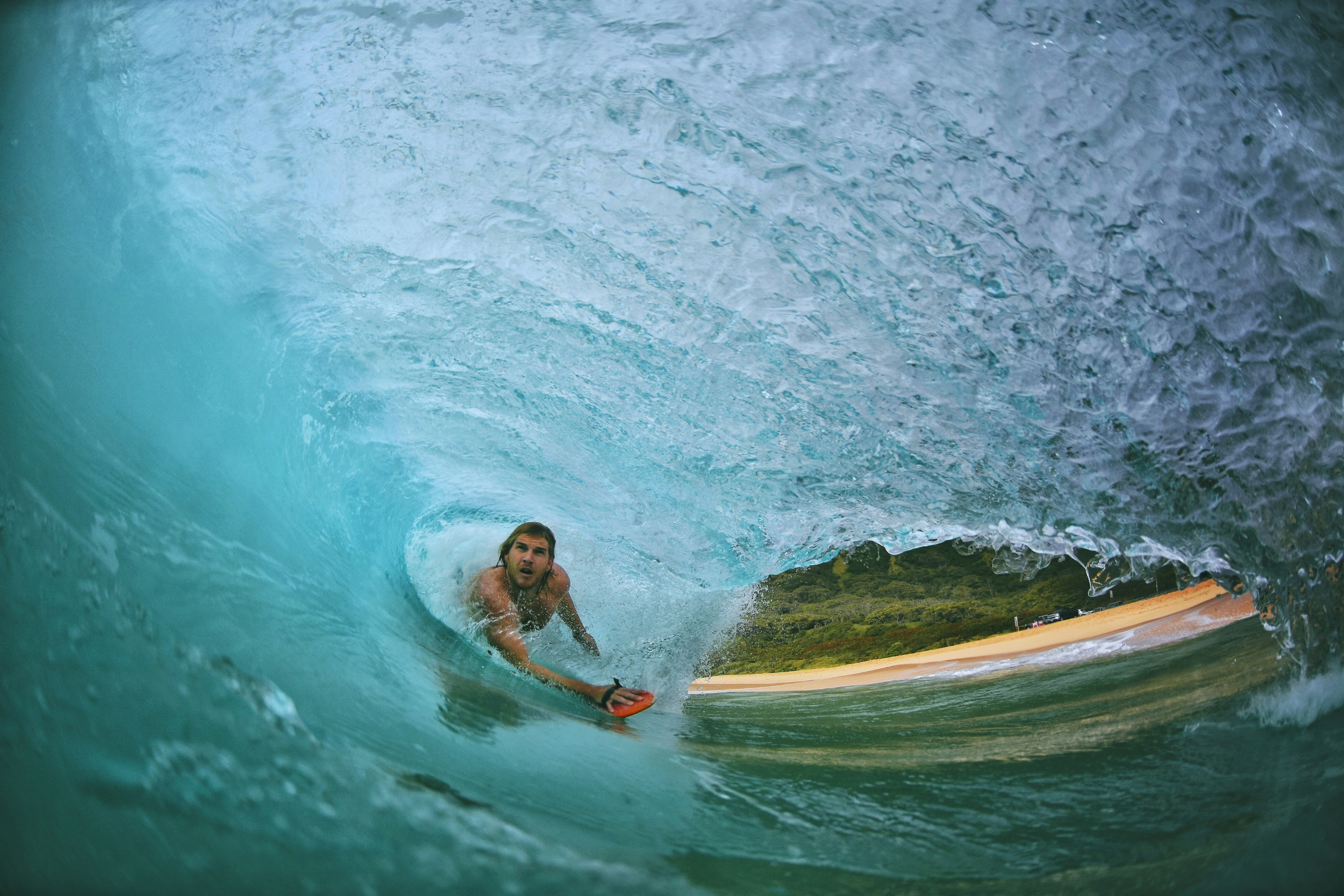 man surfing in wave on water