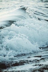 close up photography sea waves splashing on shore