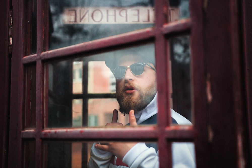 person behind brown wooden framed door