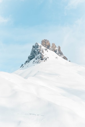 brown rock formation covered with snow at daytime