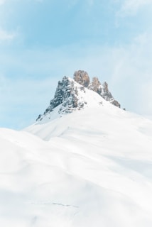 brown rock formation covered with snow at daytime